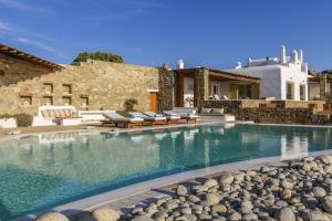 图罗斯Villa Yasmina的一个带椅子的游泳池以及一座房子