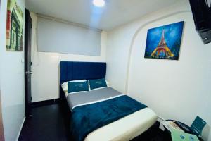 波哥大Hotel Bogota Home的小卧室配有一张带艾菲尔铁塔照片的床