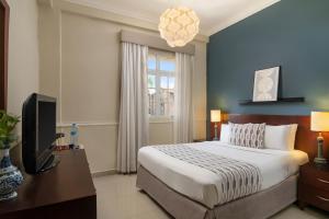 圣多明各霍德帕加勒比殖民酒店的一间卧室设有一张床、一台电视和一个窗口。
