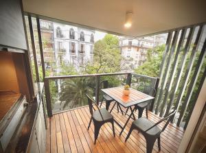 布宜诺斯艾利斯Exclusive Apartment in the Heart of Palermo Viejo PV1 by Apartments Bariloche的木制阳台配有桌椅