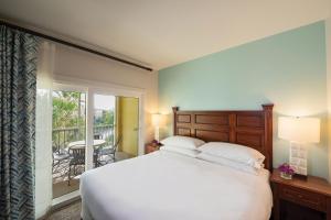 奥兰多Sheraton Vistana Villages Resort Villas, I-Drive Orlando的一间带一张白色大床的卧室和一个阳台