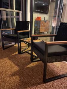 达拉斯Opulence is a way of life的客厅配有两把椅子和一张桌子