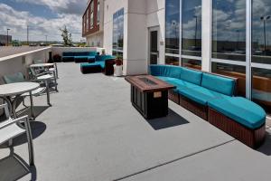 威奇托威奇托机场万豪春季山丘套房酒店的屋顶露台配有蓝色的沙发和桌椅
