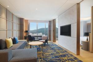 深圳深圳博林天瑞喜来登酒店的一间配备有沙发及电视的酒店客房