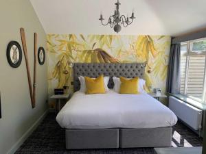 利明顿The Old Mill的一间卧室配有一张带黄色枕头的大床