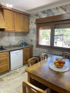 格罗韦CAMPOS DE BALEA (1ªPLANTA)的厨房配有带橙子的木桌