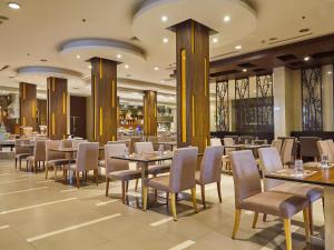 曼谷枫叶酒店的餐厅内带桌椅的用餐区