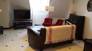 圣马丹勒博瓦雷公寓的带沙发和钢琴的客厅