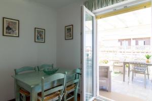 托瓦尼亚Attico Centralissimo Vista Mare的一间带桌子和滑动玻璃门的用餐室