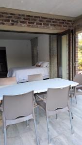 玛洛斯帕克Nanisto Bush Lodge的一张桌子和椅子,位于一个配有床的房间