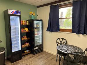 Ellison BayParkside Inn的客房设有冰箱、桌子和窗户。
