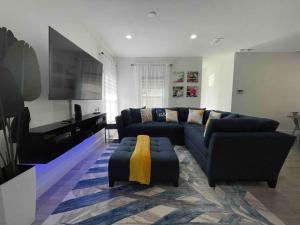 奥兰多3BD/2BTH Home Near Downtown Orlando的客厅配有蓝色的沙发和电视