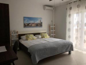 巴尔巴特纳拉布Apartments Aco的一间卧室设有一张床和一个窗口