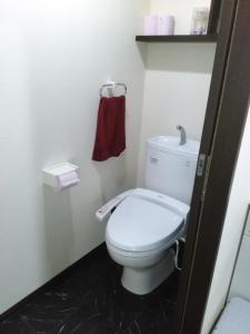 由布市YUFUKANⅡ的浴室设有白色卫生间和红色毛巾。