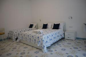马奥莱mary's apartment的一间卧室设有两张床和白色的墙壁