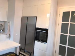 巴统Guest House Bagrationi的厨房配有不锈钢冰箱和烤箱