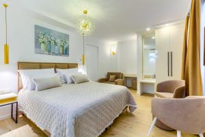 斯普利特Irini Luxury Rooms的卧室配有白色的床和椅子
