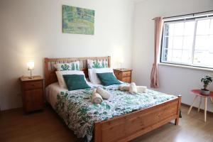 奥比多斯Casa Do Shon的一间卧室配有一张带蓝白色枕头的大床