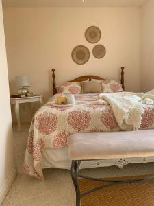 TracadiePhare des Dunes Lighthouse的一间卧室配有一张带粉色和白色棉被的床
