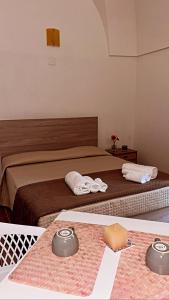 切列梅萨皮卡Le Camere Dei Mascia的一间卧室配有两张床,桌子上配有毛巾