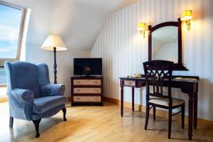 特拉利Barrow Lodge的配有椅子、书桌和镜子的客房
