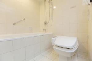 台北三德饭店的白色的浴室设有卫生间和浴缸。