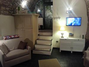 利莫内-苏尔加达Casa Limonaia San Rocco的客厅设有楼梯、沙发和电视