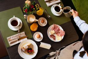 莫尔韦诺Hotel Du Lac的桌子上放着盘子和咖啡