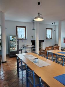 圣维托阿尔塔利亚门托奥斯特罗欧罗巴旅舍的客房配有桌椅和冰箱。