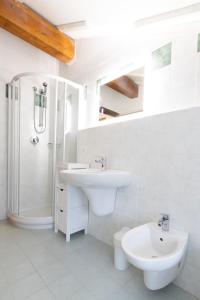 斯基奥Monolocale adiacente al centro con posto auto的白色的浴室设有水槽和淋浴。