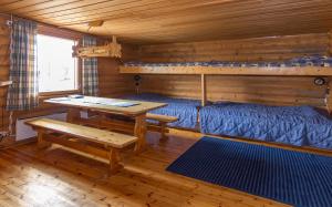 LeppäjärviTunturikeskus Galdotieva的小屋内带床和桌子的房间