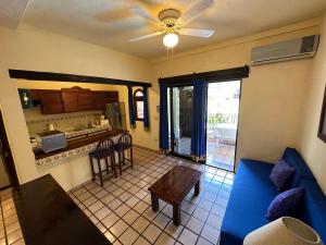 巴亚尔塔港Vallarta Sun Suites的一间带蓝色沙发的客厅和一间厨房