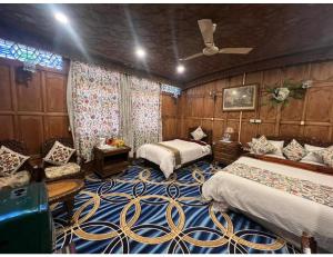 KārapurHouse Boat Shahnama, Dal Lake的一间卧室配有两张床和吊扇