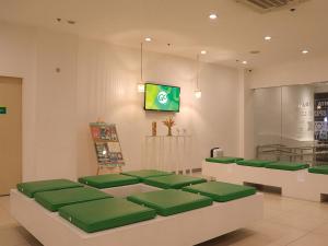 马尼拉Go Hotels Timog的餐厅内带绿色座椅的等候室