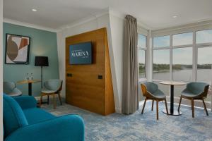 沃特福德沃特福德码头酒店的一间设有椅子、电视和窗户的等候室