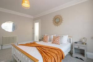 佩恩顿No.89 Stylish Ground Floor Apartment的一间卧室配有一张带橙色毯子的床