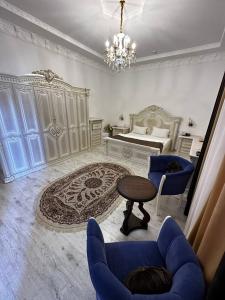 布哈拉Imperial Palace的客厅配有床和桌椅