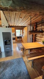 鲁卡Kelokallas 2 Ruka的客厅配有木桌和炉灶。