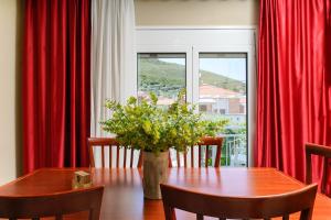 普里诺斯Elia Villa Thassos的一间设有桌子和红色窗帘的用餐室