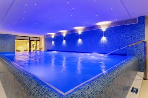因戈尔施塔特Maritim Hotel Ingolstadt的蓝色天花板的酒店游泳池