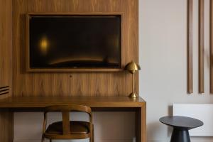 Wendake普利米尔国家博物馆酒店的一张桌子,墙上有一台电视,椅子