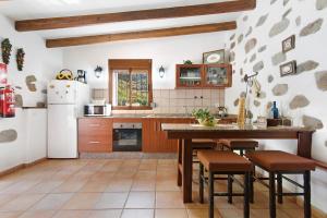 贝加德圣马特奥Casa Abuela Fela的厨房配有冰箱和桌椅