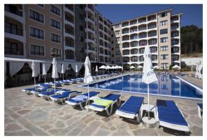 金沙Bendita Mare Apartment的酒店旁的游泳池配有躺椅和遮阳伞