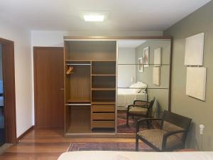 库里提巴Suite residencial, Villa da Luz的带衣柜的客房和1间带1张床的卧室