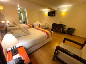 库斯科Mistico San Blas Boutique的酒店客房设有床和客厅。