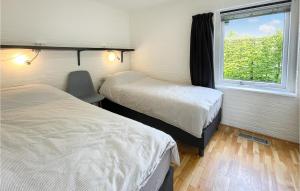 劳雷尔苏格3 Bedroom Gorgeous Home In Lauwersoog的客房设有两张床和窗户。