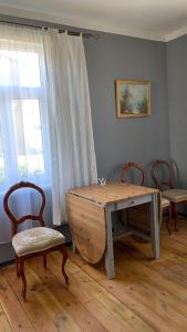 斯克伦达Skrunda Apartments Elvira的一张木桌和两张椅子