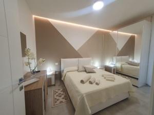 圣温琴佐Lecci al Mare的一间卧室配有一张大床和镜子