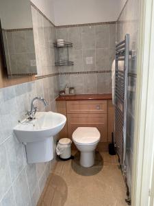 埃克塞特莱佛士旅馆的浴室配有白色卫生间和盥洗盆。