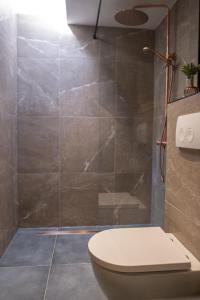 拉纳肯't Bunga huiske的一间带卫生间和玻璃淋浴间的浴室